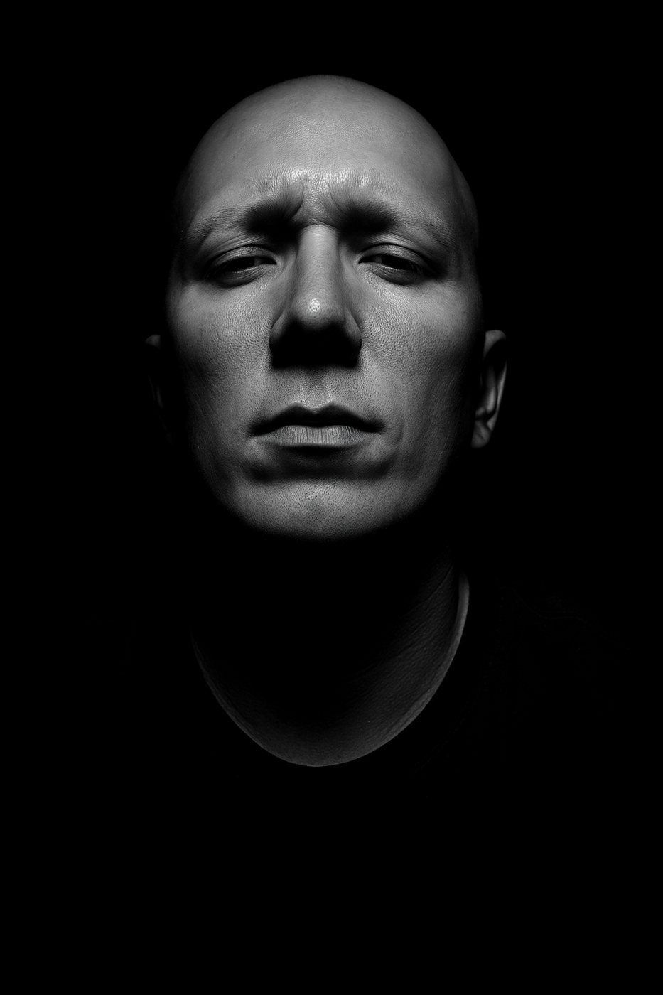 Rick Souza, photographed in low light against a dark background